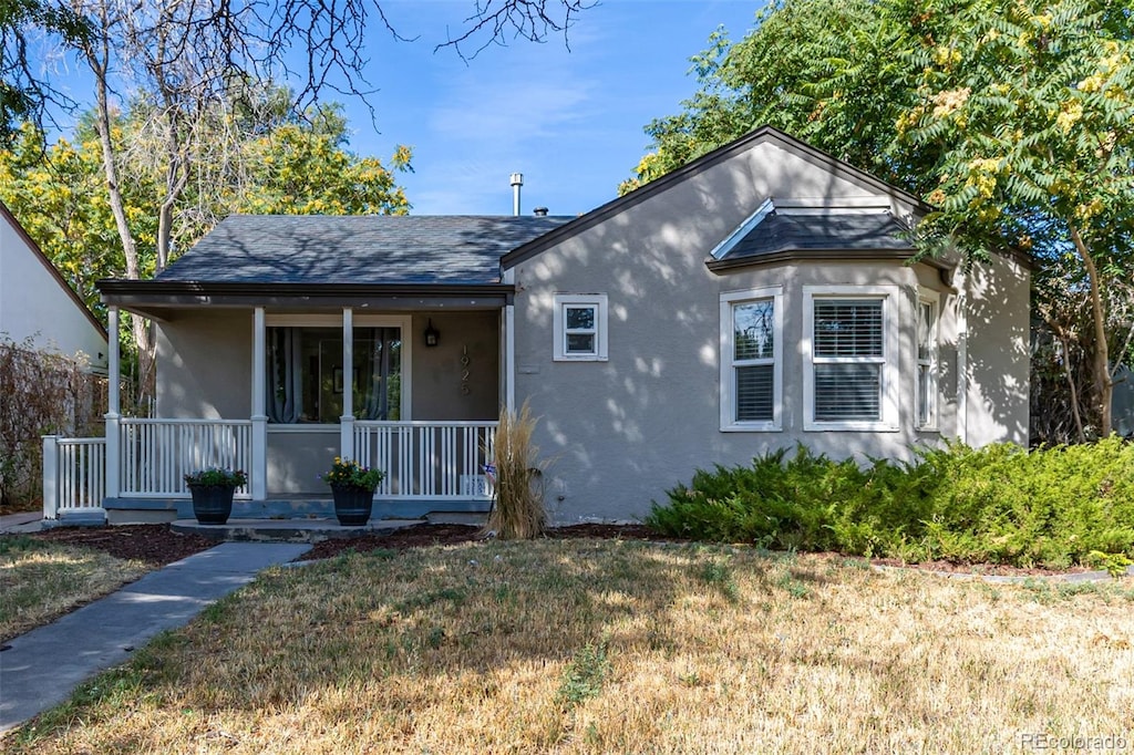 bungalow with a front yard and a porch