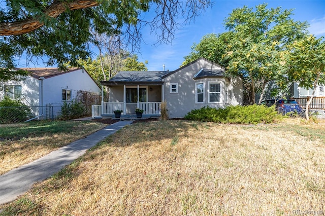 view of front of property with a front yard and a porch