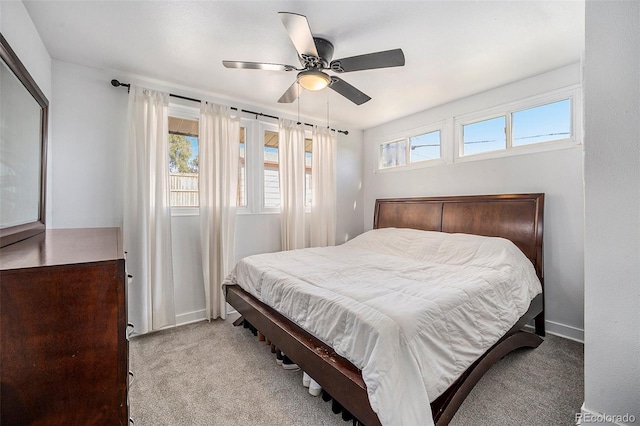 carpeted bedroom with baseboards and a ceiling fan