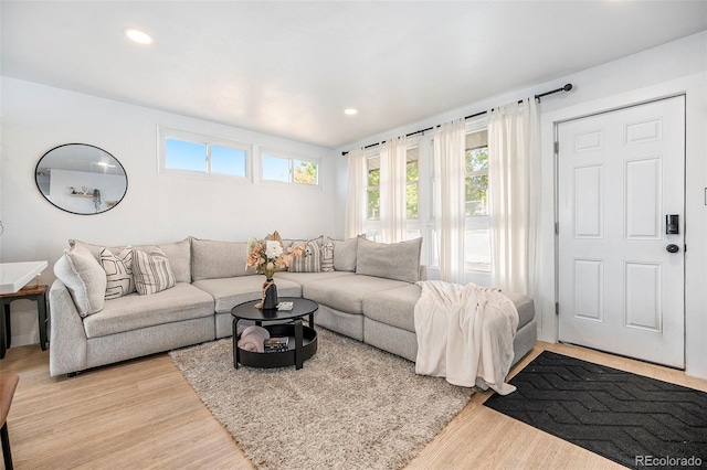 living area featuring recessed lighting and light wood-style flooring