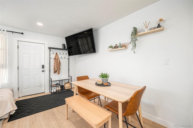 dining room with recessed lighting, baseboards, and wood finished floors