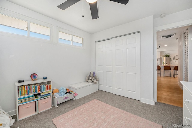 rec room with visible vents, carpet, and a ceiling fan