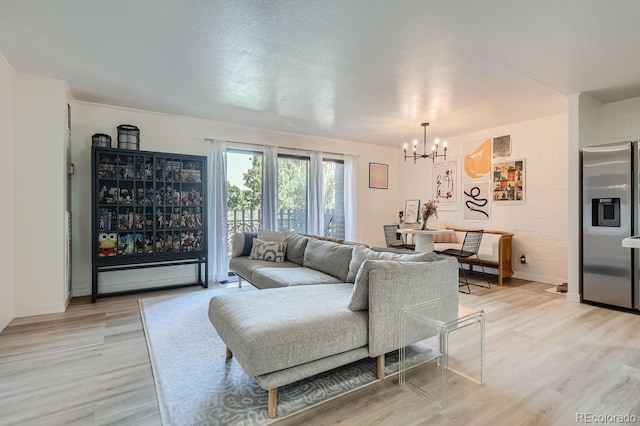 living room featuring a chandelier and light hardwood / wood-style floors