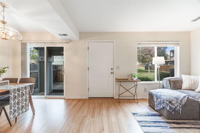 interior space with light hardwood / wood-style flooring and an inviting chandelier