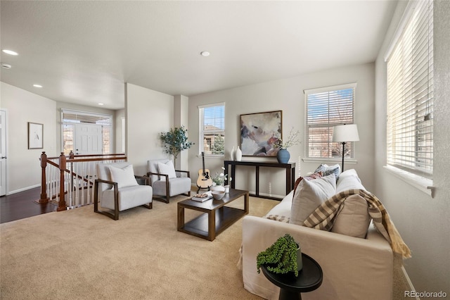 carpeted living area featuring recessed lighting and baseboards