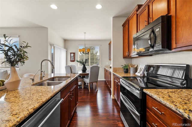 kitchen with recessed lighting, dark wood-style flooring, a sink, appliances with stainless steel finishes, and light stone countertops