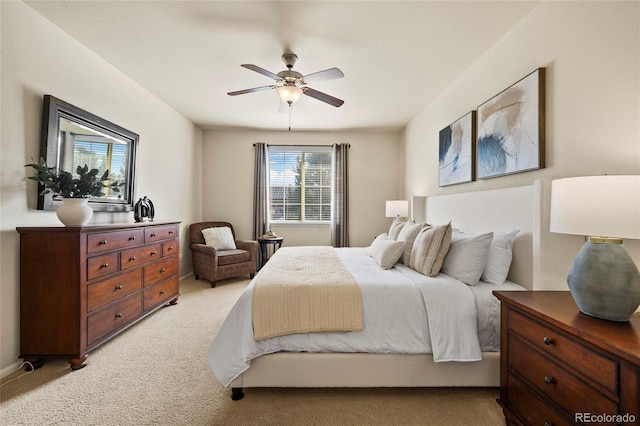 bedroom featuring light carpet and a ceiling fan