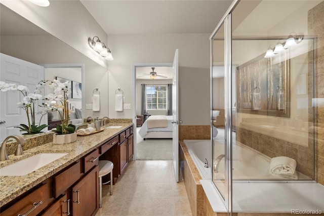 full bath with connected bathroom, a sink, a tile shower, and double vanity