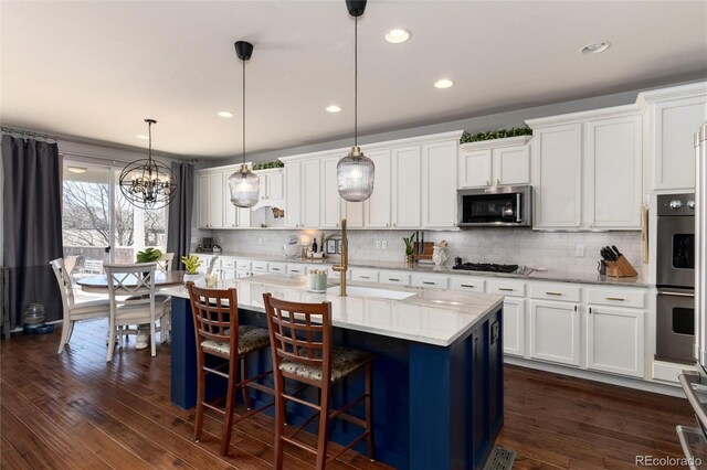 kitchen with dark wood-style floors, white cabinetry, and stainless steel appliances