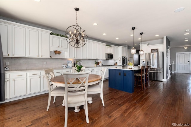 kitchen featuring appliances with stainless steel finishes, dark wood finished floors, and a sink