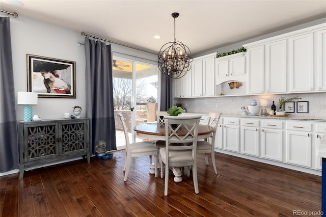 dining area with a notable chandelier and dark wood-type flooring