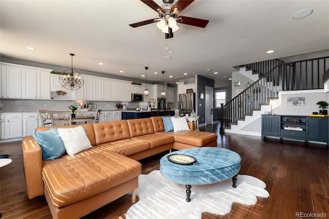 living room with recessed lighting, baseboards, dark wood-style floors, stairway, and ceiling fan with notable chandelier