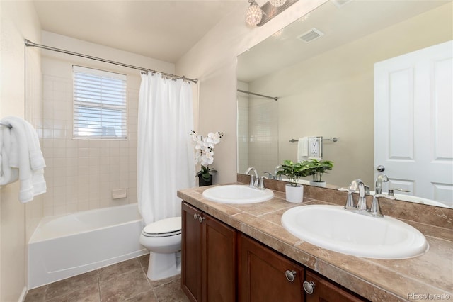 bathroom with double vanity, shower / tub combo, a sink, and toilet