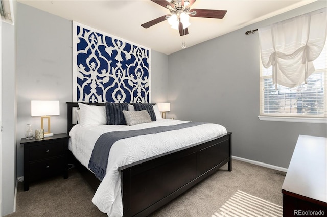 carpeted bedroom with ceiling fan and baseboards