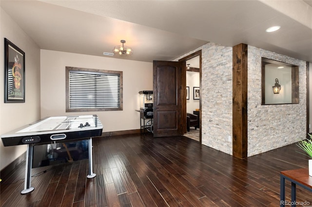 rec room featuring baseboards, visible vents, and wood finished floors