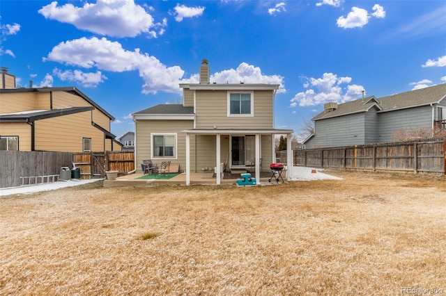 rear view of property with a patio area, cooling unit, a chimney, and a fenced backyard