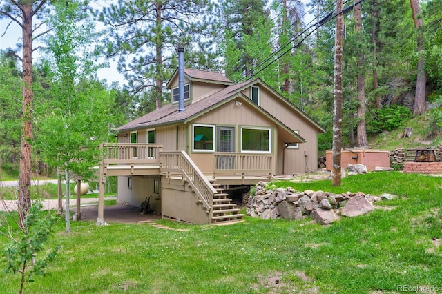 back of house featuring a yard and a deck