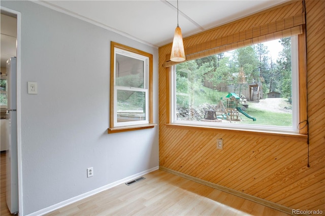 spare room featuring hardwood / wood-style floors and plenty of natural light