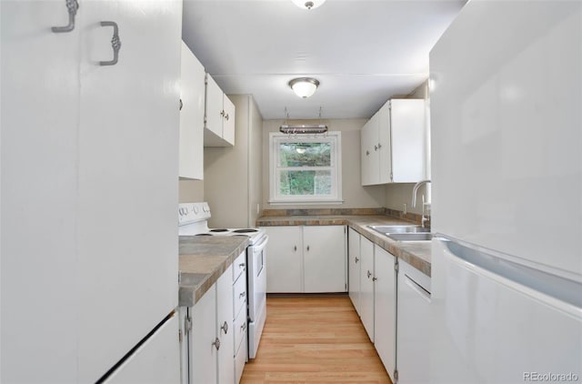 kitchen featuring white appliances, light hardwood / wood-style floors, white cabinetry, and sink