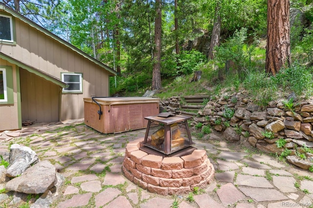 view of yard with a fire pit, a patio area, and a hot tub