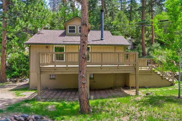 back of property featuring a deck