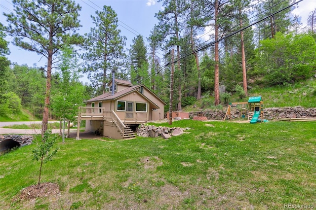 view of yard featuring a playground and a deck