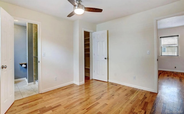 unfurnished bedroom with ceiling fan and light wood-type flooring