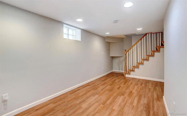 basement with light hardwood / wood-style floors