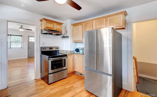 kitchen with appliances with stainless steel finishes, light brown cabinets, ceiling fan, and light hardwood / wood-style flooring