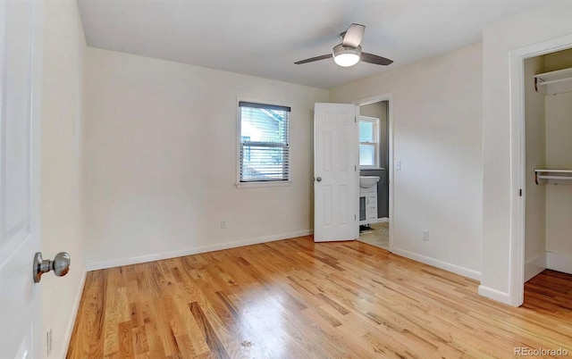 unfurnished bedroom featuring ceiling fan, light wood-type flooring, and a closet