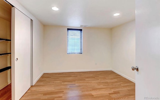 unfurnished room with light wood-type flooring