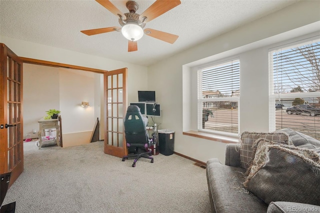 carpeted office featuring french doors, baseboards, a textured ceiling, and a ceiling fan