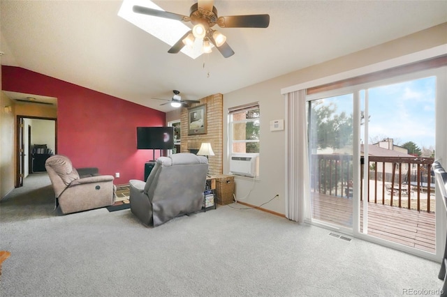 living area featuring visible vents, cooling unit, carpet flooring, lofted ceiling, and a brick fireplace