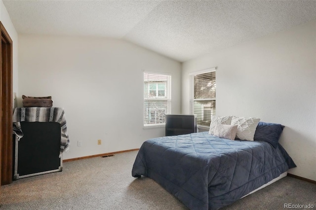 carpeted bedroom with baseboards, a textured ceiling, and lofted ceiling