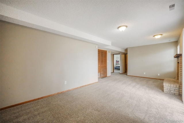 unfurnished living room with light carpet, baseboards, visible vents, and a textured ceiling