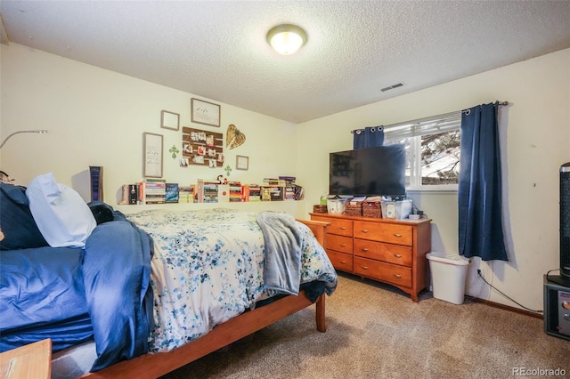 carpeted bedroom featuring visible vents and a textured ceiling