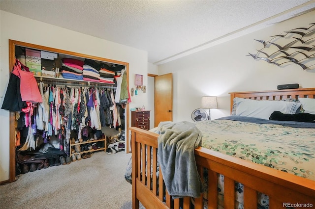 carpeted bedroom with a closet and a textured ceiling