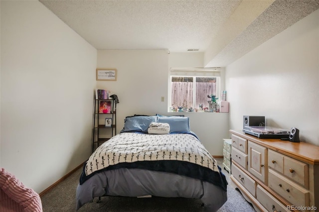 bedroom with baseboards, a textured ceiling, and carpet flooring