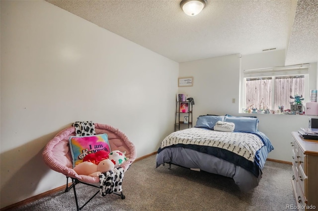 bedroom with carpet flooring, baseboards, and a textured ceiling