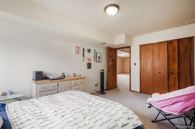 bedroom featuring a closet, light colored carpet, and a textured ceiling