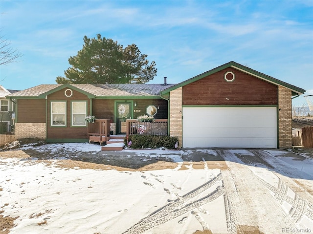 ranch-style home with driveway, brick siding, covered porch, and an attached garage