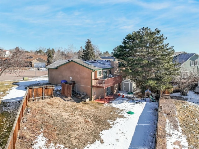 view of property exterior with fence, solar panels, an outdoor structure, and a shed