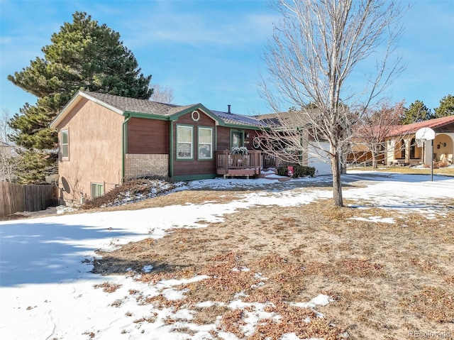 view of front facade featuring an attached garage and fence