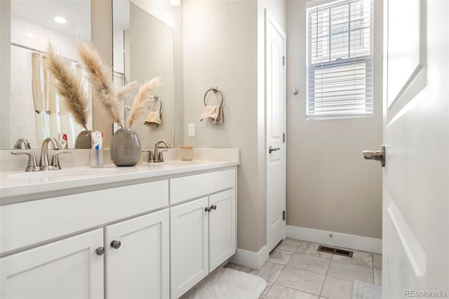 bathroom with tile patterned flooring and vanity