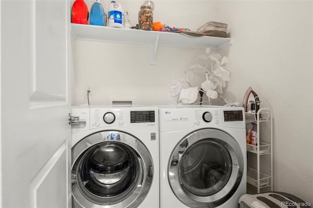 washroom featuring washing machine and dryer