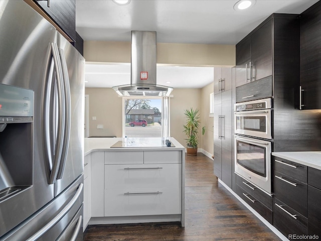 kitchen with stainless steel appliances, island exhaust hood, modern cabinets, light countertops, and dark wood-type flooring
