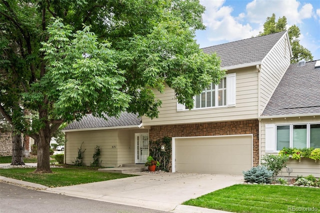 view of front facade with a garage and a front lawn