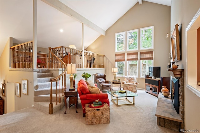 carpeted living room featuring a fireplace, beamed ceiling, and high vaulted ceiling