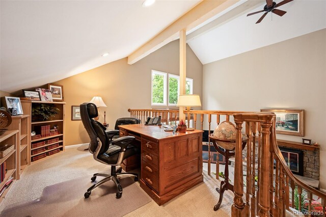 office with vaulted ceiling with beams, a fireplace, ceiling fan, and light colored carpet