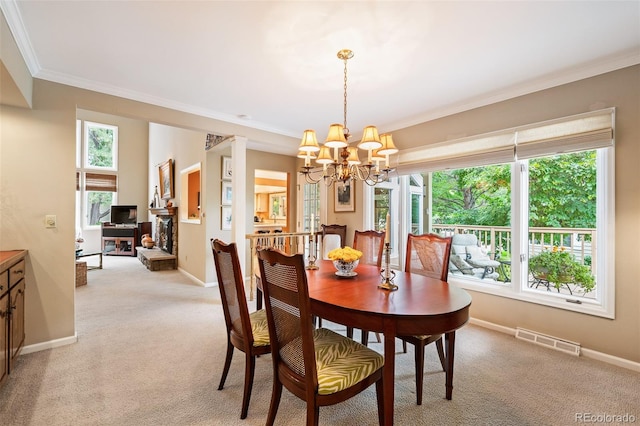 carpeted dining space with crown molding and a notable chandelier